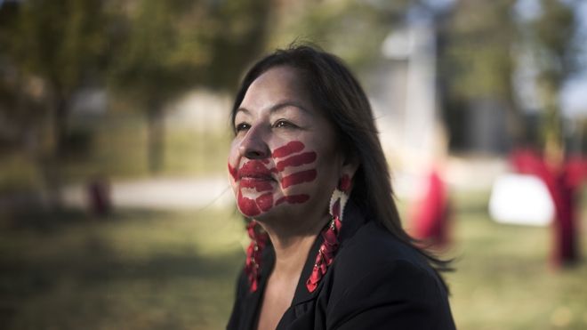 Gina Smoke with red hand-print on her face across her mouth