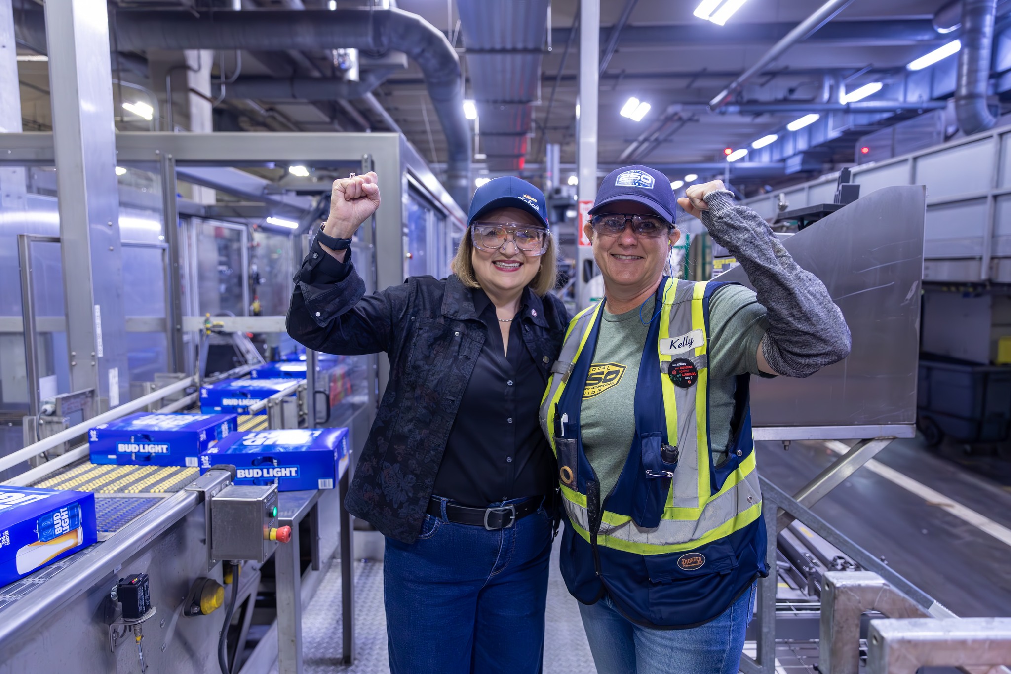 •	National President Lana Payne poses with Labett brewery worker with fists raised in air.