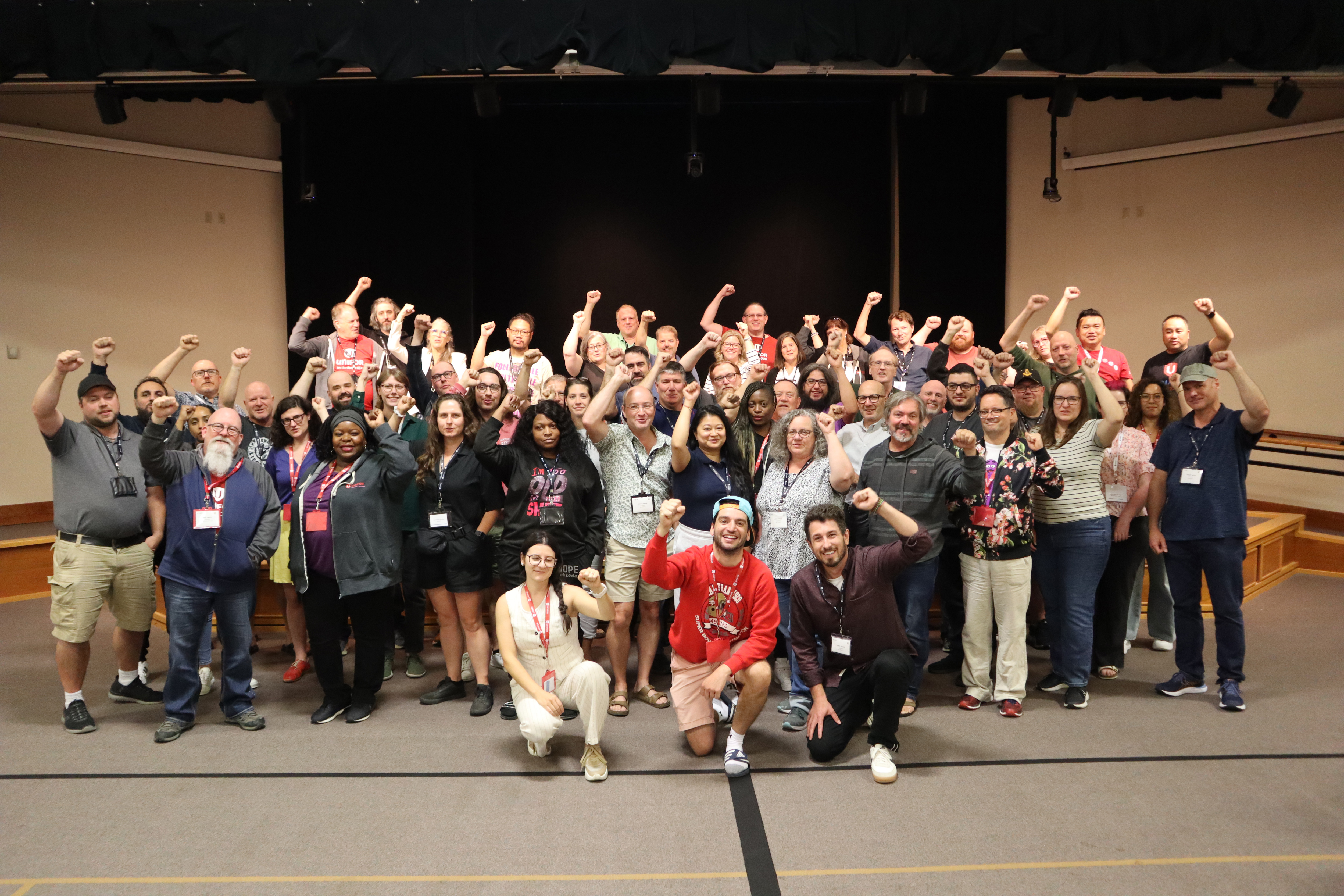 A large group posing with their fists raised