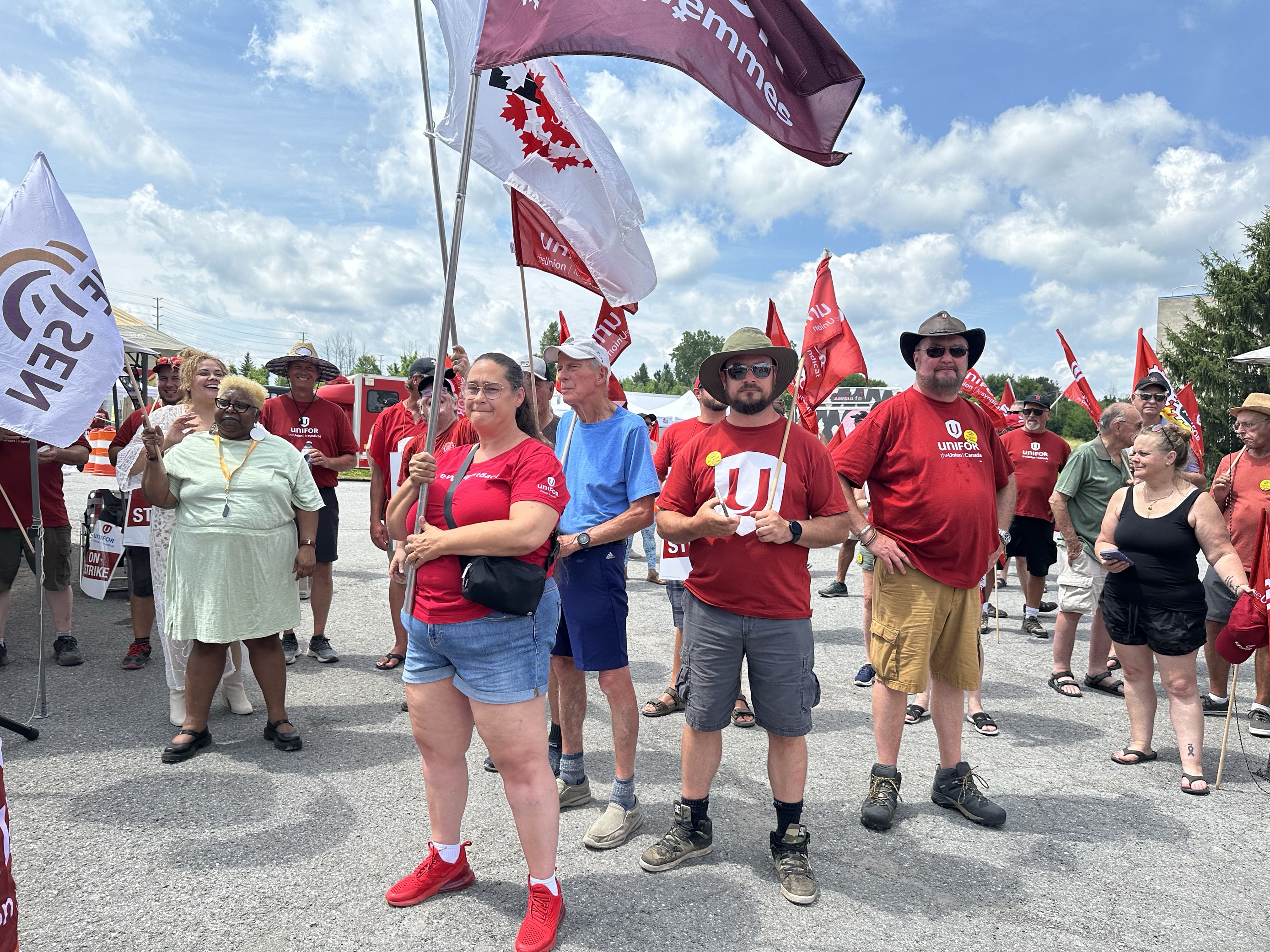 Group holding flags and wearing unifor shirts