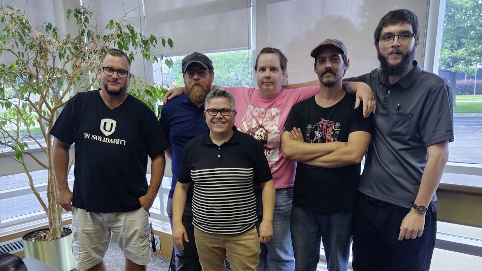 Six people posing for a photo indoors