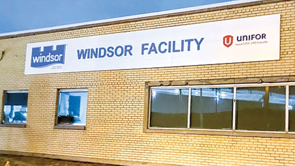 Windsor Salt and Unifor local signage on the side of a one-story yellow brick building