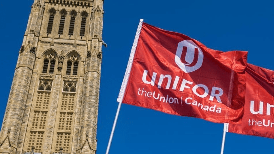 Unifor flag flying in front of Parliament Hill.