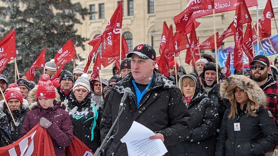 Scott Doherty speaks to a crowd of labour activists during a snow storm.