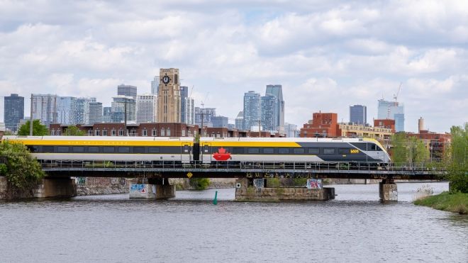 Train running in the city over a bridge