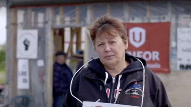 A locked-out Unifor member holding a sign.