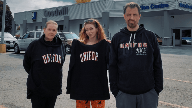 Three people standing outside in Unifor sweatshirts